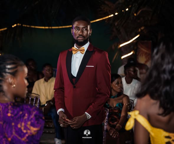 Groom in burgundy tuxedo with gold bow-tie — Marks Clothing